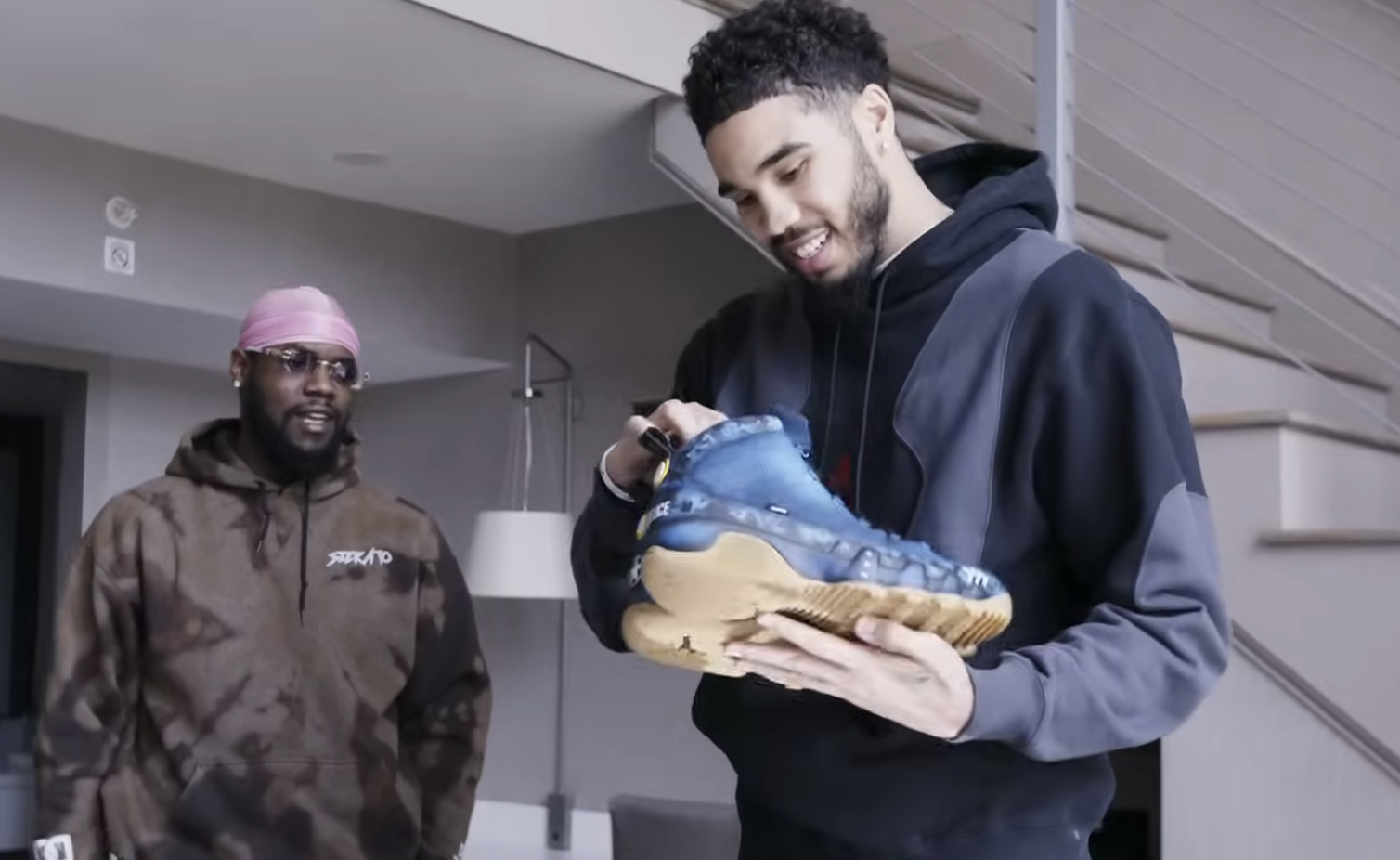 Jayson Tatum holding custom sneakers — Trick My Kicks, Overtime x Paramount Pictures