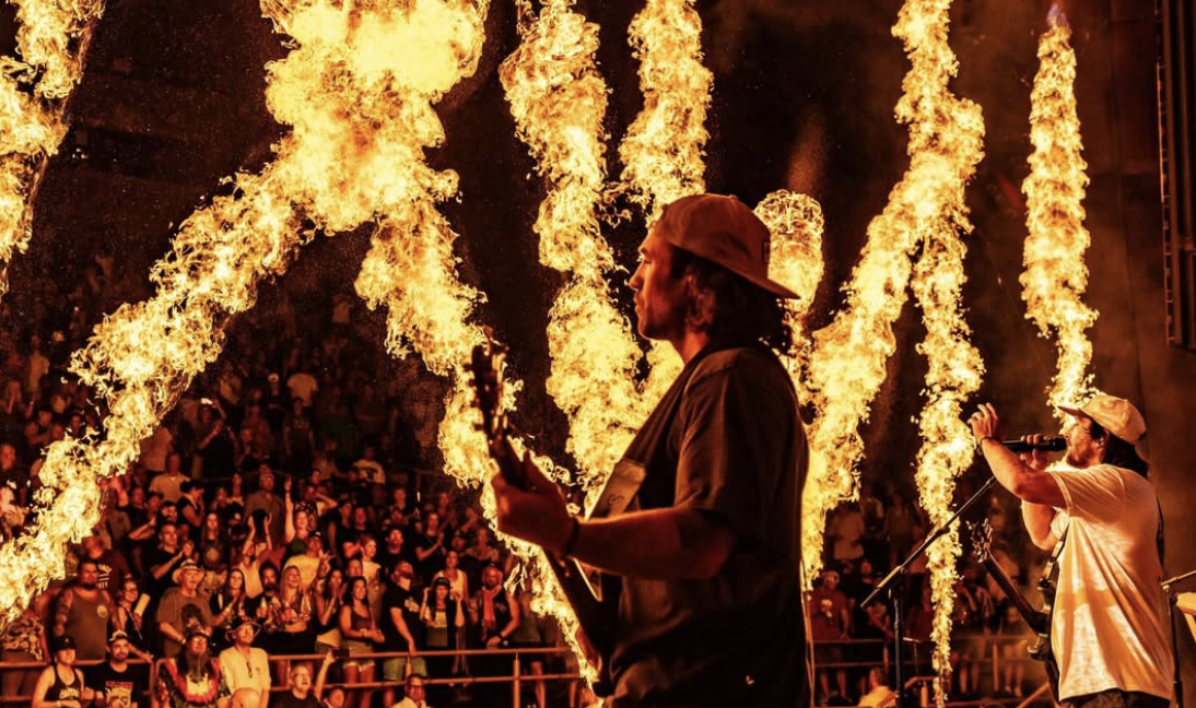 Stick Figure performing live on stage with fire pyrotechnics — World on Fire tour
