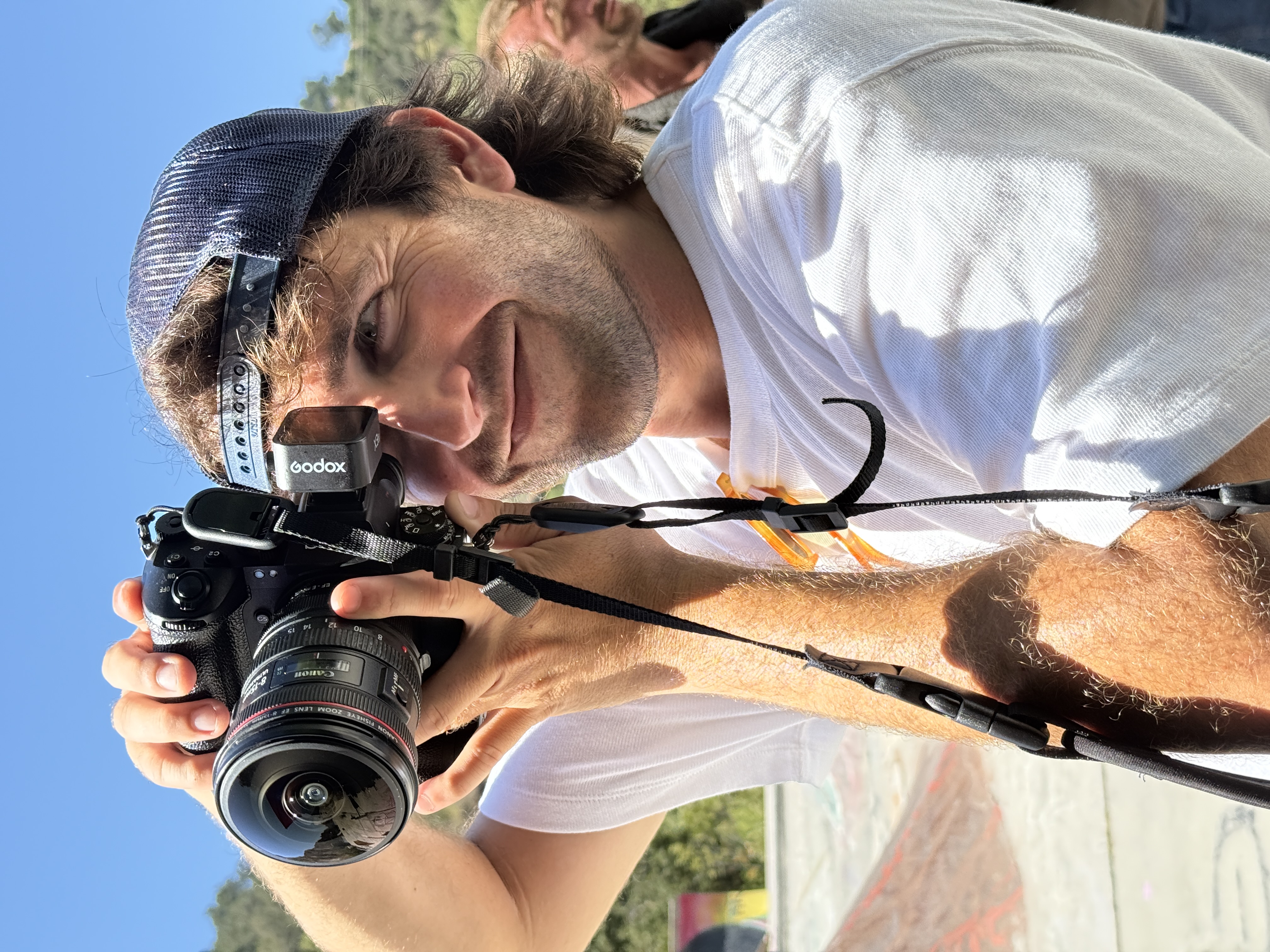 Tyler Coleman — Los Angeles content strategist and producer holding a Canon cinema camera on set at a skatepark